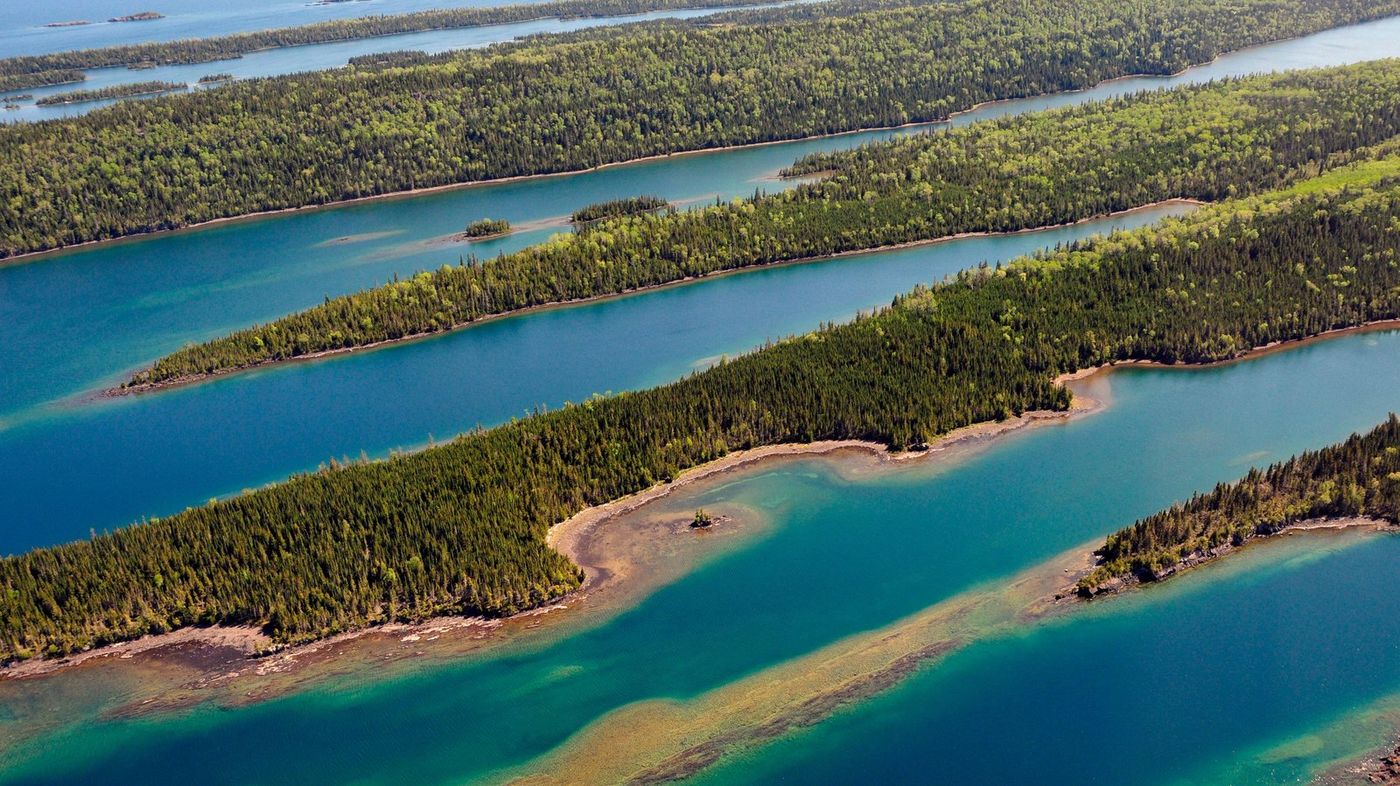 Aerial view of long, forested islands in clear water at Isle Royale National Park.