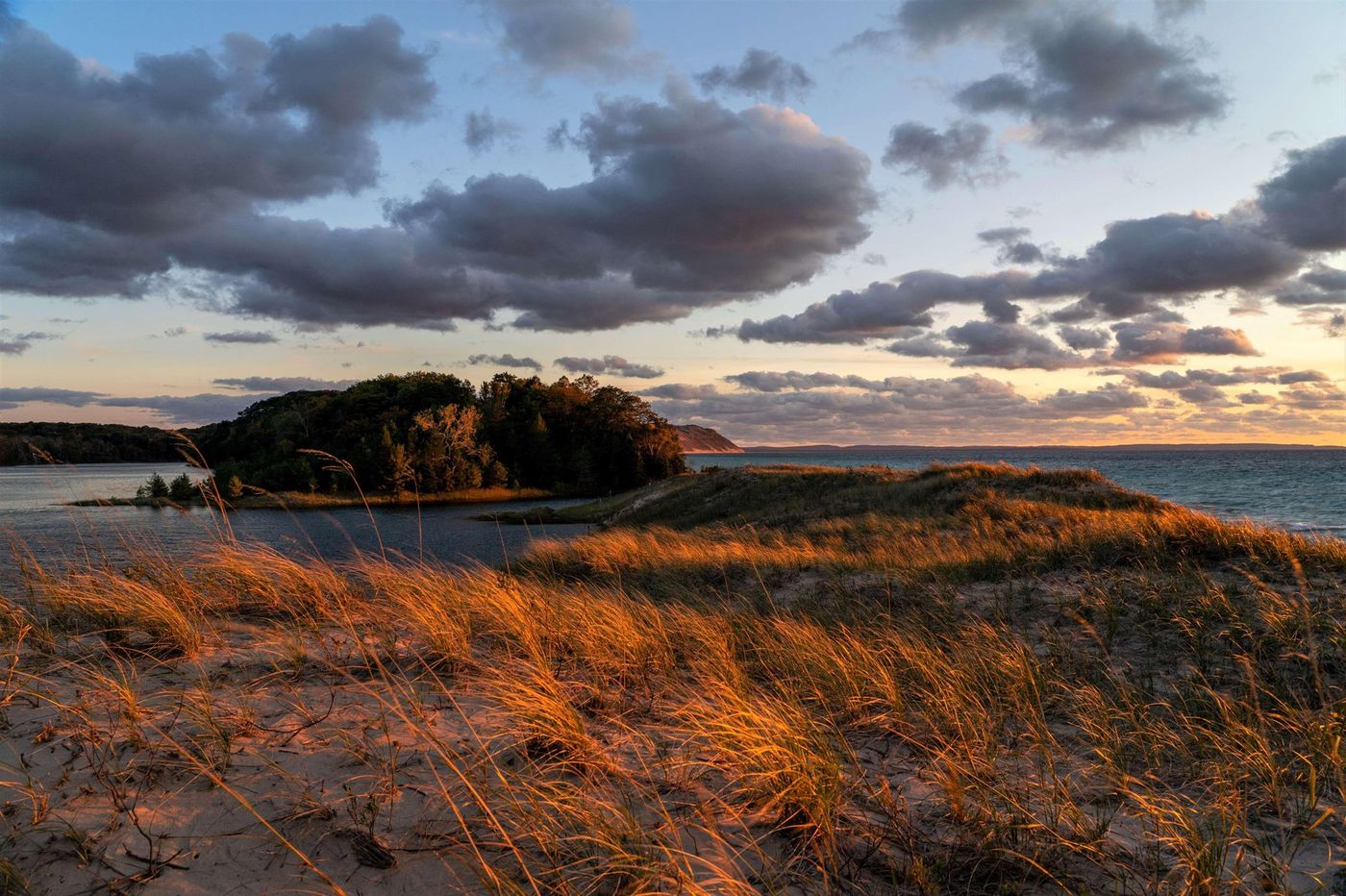 Sand dunes at sunset between two lakes at Sleeping Bear Dunes National Lakeshore.